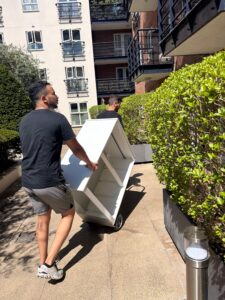 Two people moving furniture